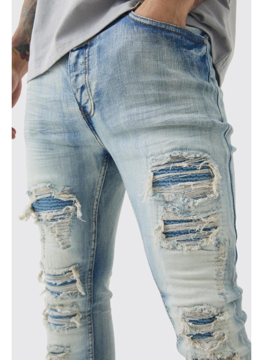 Супервузькі стрейч-блідо-блакитні байкерські джинси з рваними і відновленими накладками