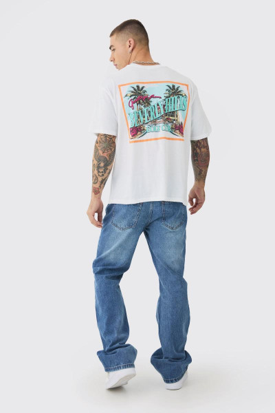 Розслаблені джинси з кльошем середнього синього кольору